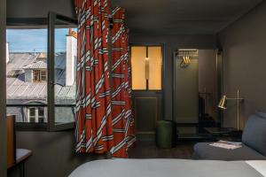 巴黎皮埃蒙特卢浮宫酒店的客房设有一张床和一个美景窗户。