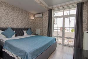 基希讷乌克拉希酒店的一间卧室设有一张床和一个大窗户
