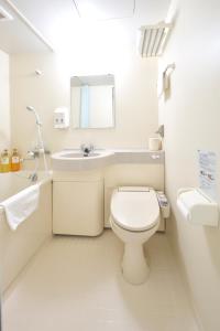 藤枝Fujieda Ogawa Hotel フジエダオガワホテル的白色的浴室设有卫生间和水槽。