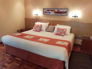 内罗毕Spurwing Guest House的酒店客房配有一张带枕头的大床