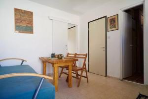 内韦伊兰Irit's Apartment的配有桌子、椅子和床的房间