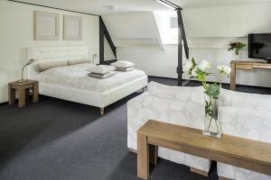 德纳瑞德德纳瑞德卡斯迪尔酒店的一间卧室配有一张床、一张沙发和一台电视。