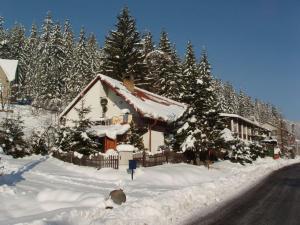上贝奇瓦Chata Barborka的一条雪覆盖着的房屋,位于道路旁