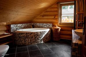 布布拉瓦Srub Bublava 806的小屋内设有一间带浴缸和水槽的浴室