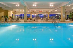 哈里斯堡哈里斯堡赫希红狮酒店的一座配有桌椅的酒店游泳池