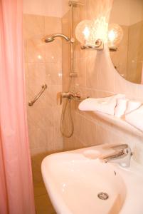 海牙怡东酒店的带淋浴、盥洗盆和卫生间的浴室