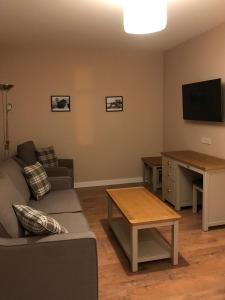 勒威克Nort Bode Apartments的带沙发、桌子和电视的客厅