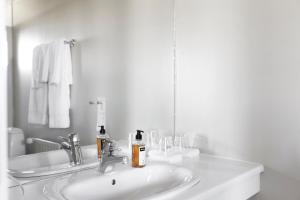 霍芬赫本酒店的白色的浴室设有水槽和镜子