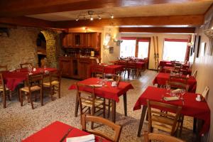 维拉尔-德朗拉法姆杜博阿酒店的一间餐厅,房间内设有红色的桌椅