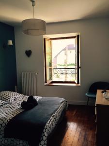 圣若里奥Maison de charme " Les Cyclamens"的一间卧室设有一张床和一个窗口