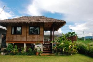 Ban Mai心灵庇护所旅馆的一间有稻草屋顶的小房子