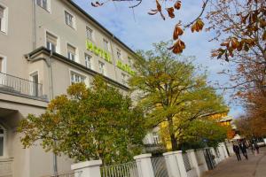 慕尼黑塞贝尔酒店的建筑的一侧有绿色标志