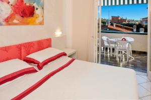 巴多利诺Blue Lake Residence - Bardolino的一间卧室配有一张床,阳台配有桌子