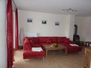 奥斯特巴德里克Ferienhaus NEMO的客厅配有红色的沙发和桌子