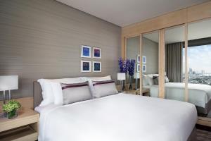 曼谷曼谷安凡尼+河畔酒店的卧室设有一张白色大床和一扇窗户。