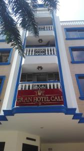 卡利Gran Hotel Cali的上面有红白标志的酒店大楼