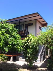 通奈潘海滩泰式露台别墅的前面有楼梯和树木的房子