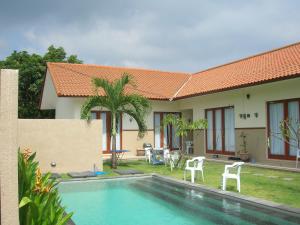 沙努尔Fruits Villa的一座带游泳池和房子的别墅