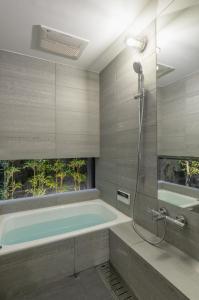 京都奔腾公寓 的一间带浴缸和淋浴的浴室
