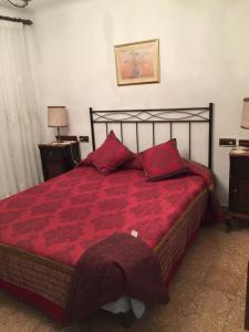 AlcampelCasa vitorianet的一间卧室配有一张红色棉被的床