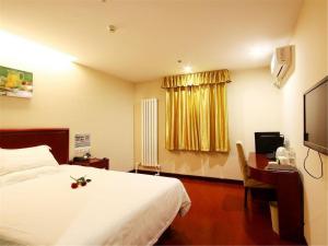 上海格林豪泰上海中山沪太商务酒店的酒店客房配有一张床和一张带电脑的书桌