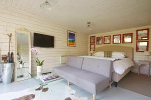 巴斯威特血斧康比草坪旅馆的一间卧室配有一张床、一张沙发和一台电视。