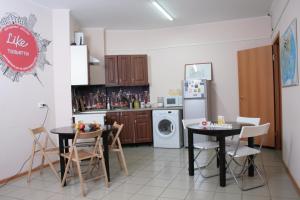 陶里亚蒂陶里亚蒂莱克旅舍的厨房配有2张桌子和1台洗衣机和烘干机