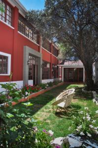 拉巴斯阿纳米精品酒店的红色建筑的院子的长凳