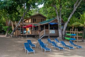 桑迪湾Blue Island Divers Casita Azul的一组椅子和一个带游乐场的房子