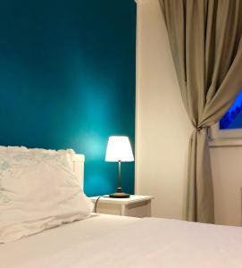 蒂米什瓦拉AVA Apartments ADORA FOREST 1的卧室配有白色的床和蓝色的墙壁