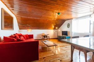 里斯本Bairrus Lisbon Apartments - Alfama III的客厅配有红色的沙发和桌子