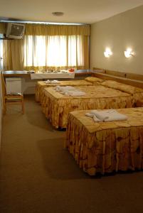 圣拉斐尔Hotel San Rafael的酒店客房设有三张床和一架钢琴