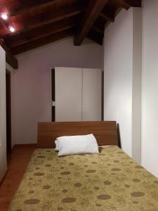 奥尔塔圣朱利奥Casa Vacanza Isola的一间卧室配有一张带白色枕头的床