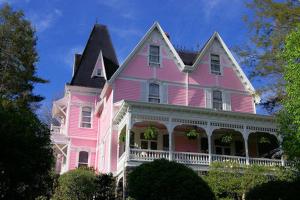阿什维尔Cedar Crest Inn的黑色屋顶的粉红色房子