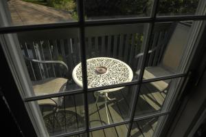 滨湖尼亚加拉Butler Creek House的一张桌子和椅子,坐在天井上,透过窗户