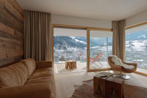 斯拉德明Sun Lodge Schladming by Schladming-Appartements的带沙发和大窗户的客厅