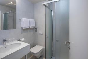 普纳特Falkensteiner Hotel Park Punat的浴室配有卫生间、盥洗盆和淋浴。