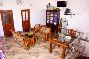 本托塔Channa Villa & Tours的客厅配有木椅和桌子