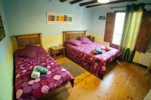 阿尔内迪略La Fuente de Arnedillo的一间卧室设有两张床,里面饲养着动物。