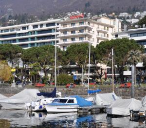 洛迦诺吉拉尼奥拉克酒店的一群船停靠在港口,有一座建筑