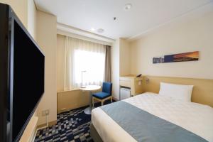 神户神户三宫东急REI酒店的配有一张床和一台平面电视的酒店客房