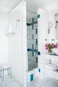 赖兴瑙Insel-Hof Reichenau Hotel-garni的带淋浴和盥洗盆的白色浴室