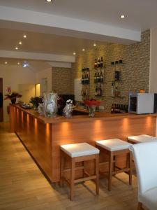 赖讷莱茵河-奥特斯塔德特德酒店的一个带两个凳子的厨房里的大型木制酒吧