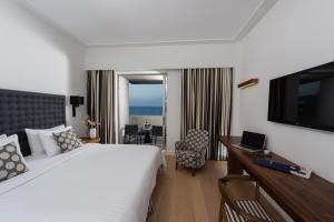 海若克利欧拉奎拉亚特兰蒂斯酒店的配有一张床和一台平面电视的酒店客房