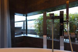 凯撒斯劳滕凯撒斯劳滕萨克斯城市设计酒店的带浴缸的浴室和窗户。