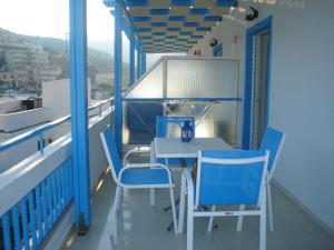 巴利恩依克诺玛奇思公寓的阳台配有蓝色的桌椅。
