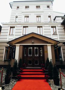 切尔诺夫策森特尔马尼亚电影院酒店的前面有红地毯的白色建筑