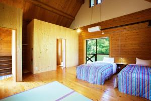 Bungoono清川旅舍 的木墙客房的两张床