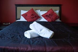 埃尔森汉姆得萨利斯伦敦斯坦斯特德酒店的一张带两条毛巾和枕头的床