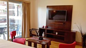 布宜诺斯艾利斯Aparts Temporarios的酒店客房配有电视、桌子和椅子。